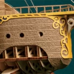 Close - up of a 3D wooden puzzle of a fantastical spaceship, showcasing ornate carvings and design elements