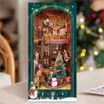 A festive DIY book nook kit featuring a Christmas-themed jingle cabin, complete with a snowman, gifts, a Christmas tree, and Santa sliding down the roof.