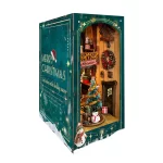 A festive DIY book nook kit featuring a Christmas-themed jingle cabin, complete with a snowman, gifts, a Christmas tree, and Santa sliding down the roof.