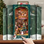 A beautifully crafted Christmas-themed DIY book nook featuring a festive cabin scene with a touch-activated button to light up the display.