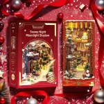 A Christmas-themed DIY book nook kit, designed to resemble a miniature Diagon Alley scene with festive decorations, lights, a snowman, and a Christmas tree, placed in a cozy window setting with snow falling outside.