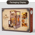 The packaging of the coffee house DIY book nook kit, featuring an image of the assembled kit on the front. The packaging also includes images of the detailed interior scenes on the side.