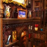 Close - up of a DIY book nook kit's interior showing ornate shelves with vases, framed pictures, and a decorative archway.
