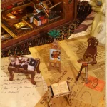 "Close - up of a DIY book nook kit pieces including a desk, books, an easel with a painting, and a telescope."