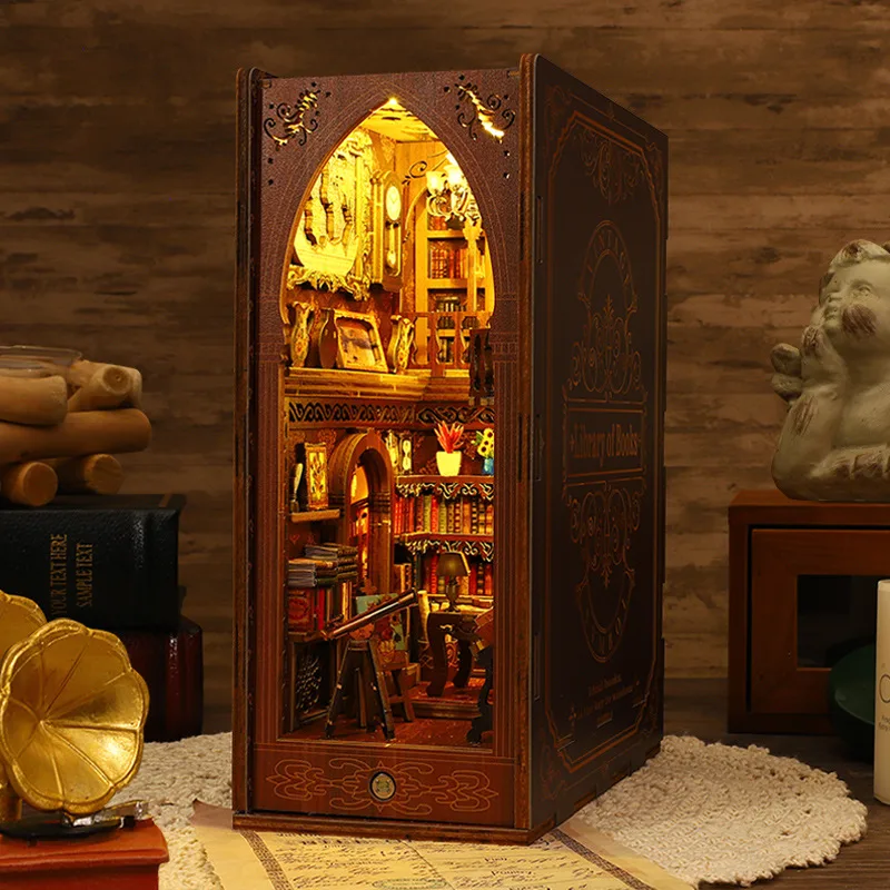 A handcrafted DIY book nook kit featuring a miniature library with wooden bookshelves, a cozy reading nook, and warm lighting, designed to fit between books on a shelf.