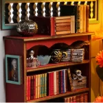 A close-up of a beautifully crafted DIY miniature house featuring a vintage bookshelf filled with tiny books, scrolls, and decorative items, capturing the cozy ambiance of a European bookstore.