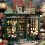 A detailed miniature of a magic wand shop with a green exterior, large windows displaying magical items, and "Magic Wand" signage.