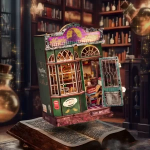 The Magic Shop Book Nook Kit levitating above an open book in a dimly lit library setting, with shimmering effects.