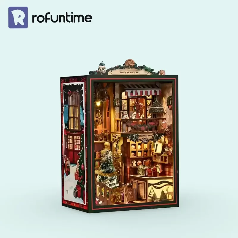Fully assembled and lit Rofuntime Christmas Shop DIY Book Nook Kit on a light blue background.