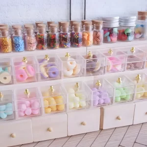 A display shelf filled with miniature food items like donuts and macarons.