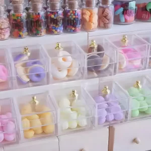 A close-up of miniature donuts and macarons in a display case.