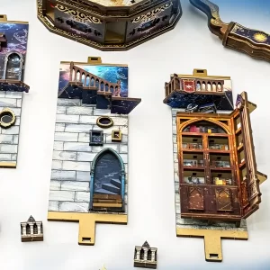 Flat and partially assembled wooden pieces of The Lantern of Galaxy 3D Wooden Puzzle, showing wall sections with cosmic patterns, a staircase, and a bookshelf.