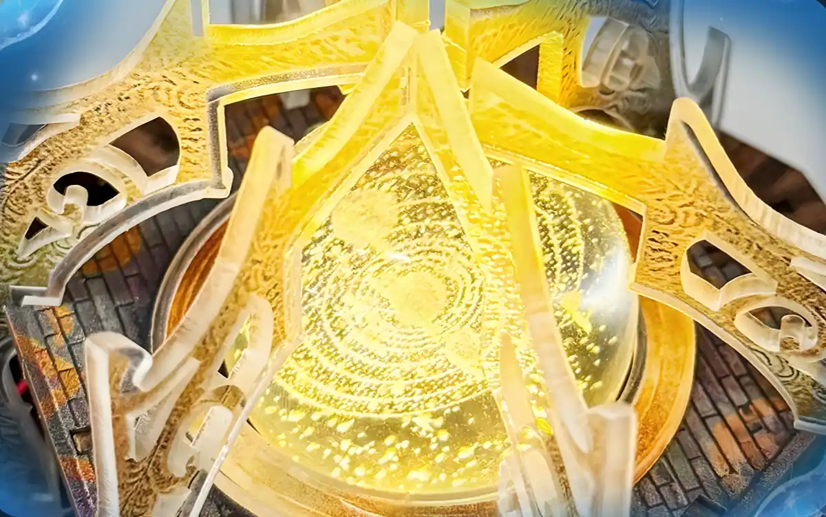 Close-up of a glowing, spherical object surrounded by ornate golden structures at the top of The Lantern of Galaxy 3D Wooden Puzzle.