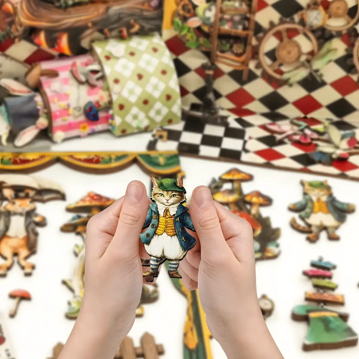 Hands holding a small, flat wooden cutout of a dressed cat character from the Puppet Theater Book Nook Kit.