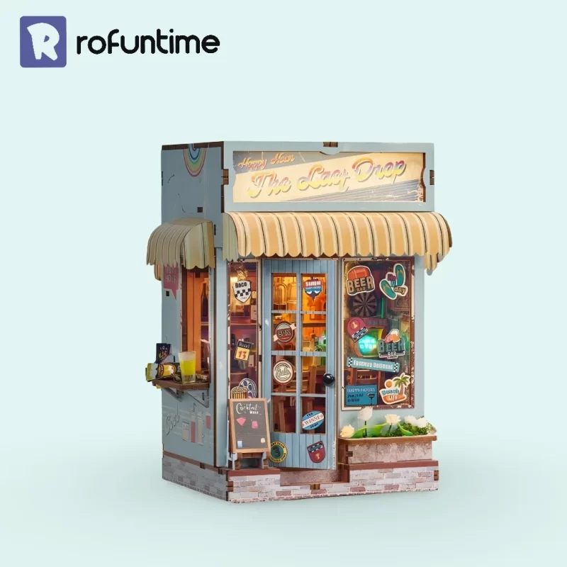 A blue miniature beach bar book nook kit with a yellow awning, featuring windows and a door.