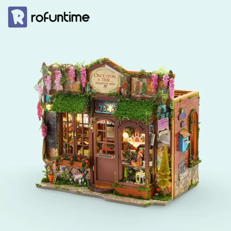 An isolated 3D product shot of the fully assembled dollhouse kit from an angled view, showing its detailed exterior with vines, lights, and a 