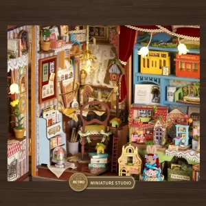 Close-up of the miniature dollhouse workshop interior, showing a chair, a cuckoo clock, books, and various tiny crafting supplies under a hanging light.