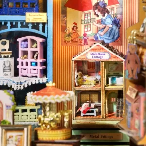 Close-up of the dollhouse interior, focusing on the "Story Book Cottage" with two visible floors, a golden carousel, and a tiny pink dollhouse on a shelf.