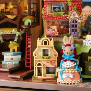 Close-up of the dollhouse interior, showing a stuffed rabbit figurine in a decorative basket, a miniature "Tea House," and a two-story dollhouse model with a ladder leaning against a stack of books.