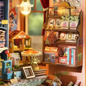 Detailed interior shot of the dollhouse, showing a bookshelf with tiny books and decorations, a miniature "Bakery Shop," a "Story Book Cottage," and a golden carousel.