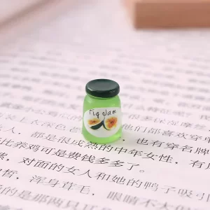 A single fig jam jar miniature on a book page, a detailed food-themed miniature.