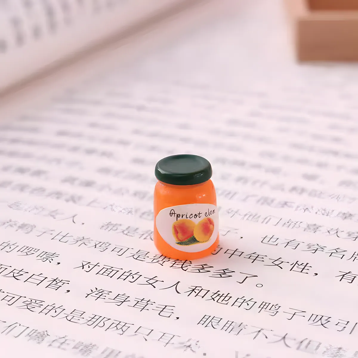 A single apricot jam jar miniature, a bright food-themed dollhouse miniature.