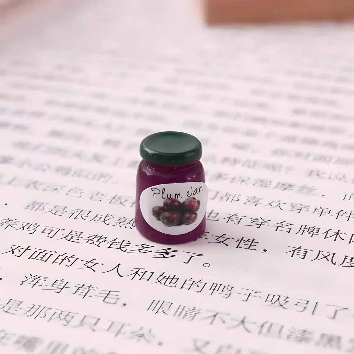 A single plum jam jar miniature, a detailed food-themed dollhouse miniature.