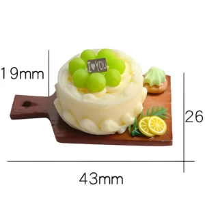 An image of a miniature green grape cake on a wooden board with measurements: cake height 15-19mm, board width 43mm, and board length 26mm.