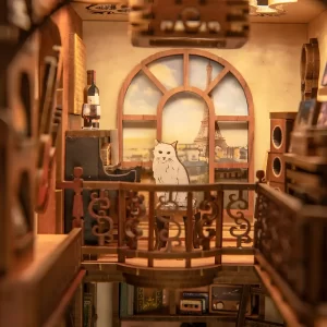 The Secret Rhythm book nook with a miniature cat on the second-floor balcony.