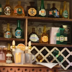 Detailed miniature wine cabinet of the Vanchy Tavern Miniature House with a variety of tiny bottles.