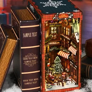 Lighted Christmas book nook displayed between vintage-style books on a snowy surface.