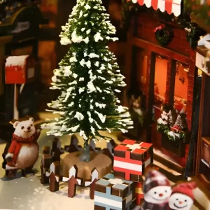 Miniature Christmas trees and colorful gift boxes in a snowy DIY book nook.