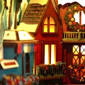 Close-up of exterior buildings from a Christmas Lane book nook with glowing lights.