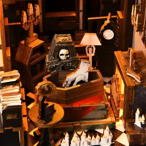 Close-up of a broken hand in a coffin inside the Dark Family book nook.