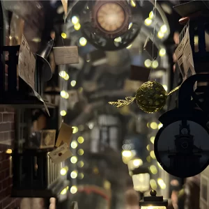 Close-up on a flying golden snitch inside a magical miniature train platform book nook.