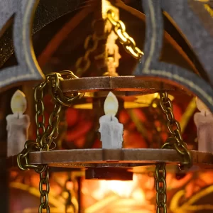 Close-up of the elegant, glowing miniature chandelier inside the throne hall diorama.
