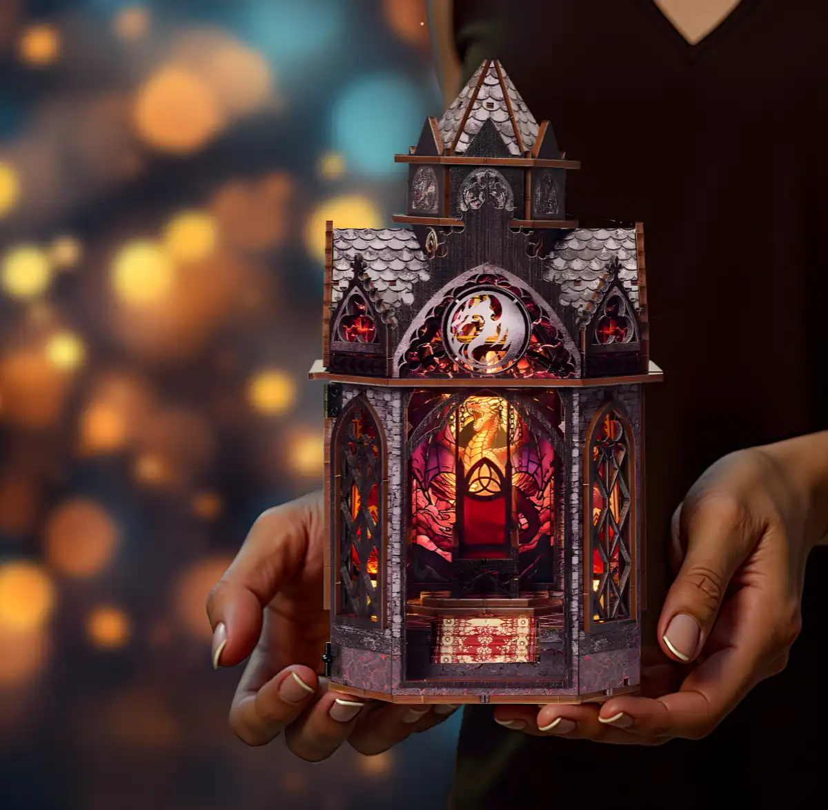 Lit Spire of the Wyrm book nook held in hands, showcasing the detailed dragon bookshelf insert.