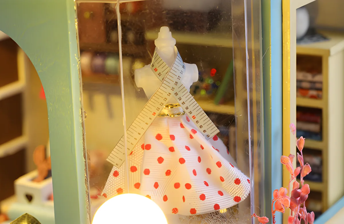 Miniature Tailor Shop dollhouse, vintage mannequin, red polka dot dress, sewing machine detail.