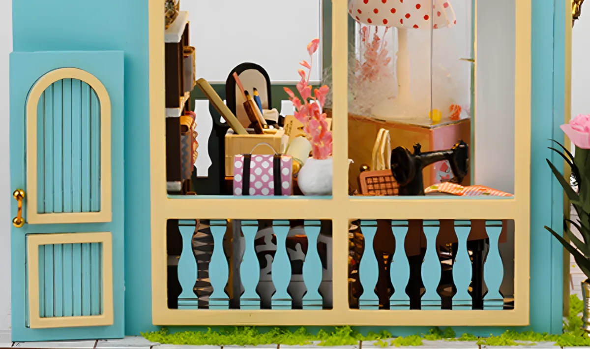 Miniature Tailor Shop window view, vintage sewing machine, fabrics and DIY craft details.