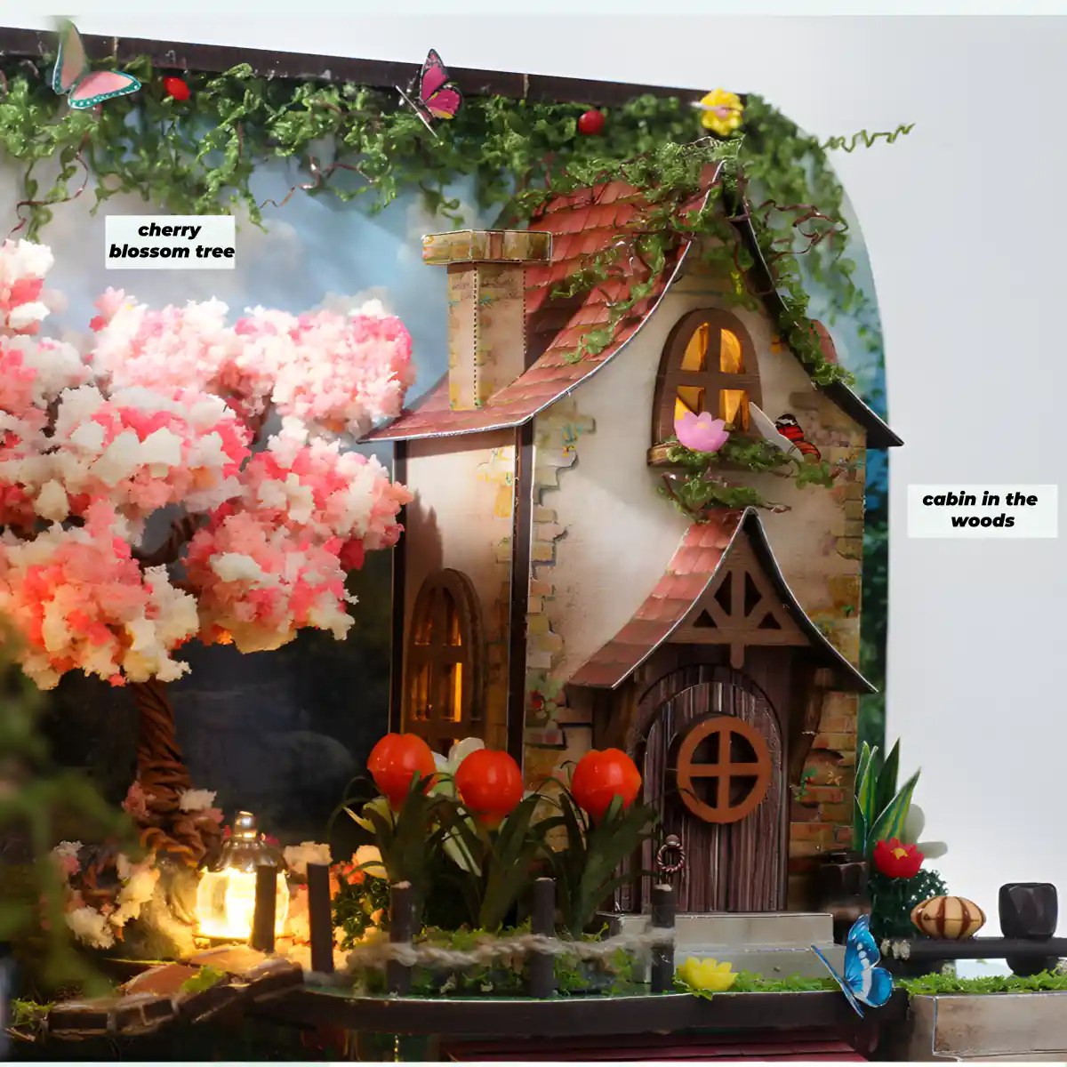 Miniature cabin in the woods with a pink cherry blossom tree.
