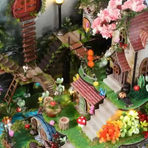 Panoramic view of the Whispering Woods Dollhouse, featuring miniature cottages and bridges.