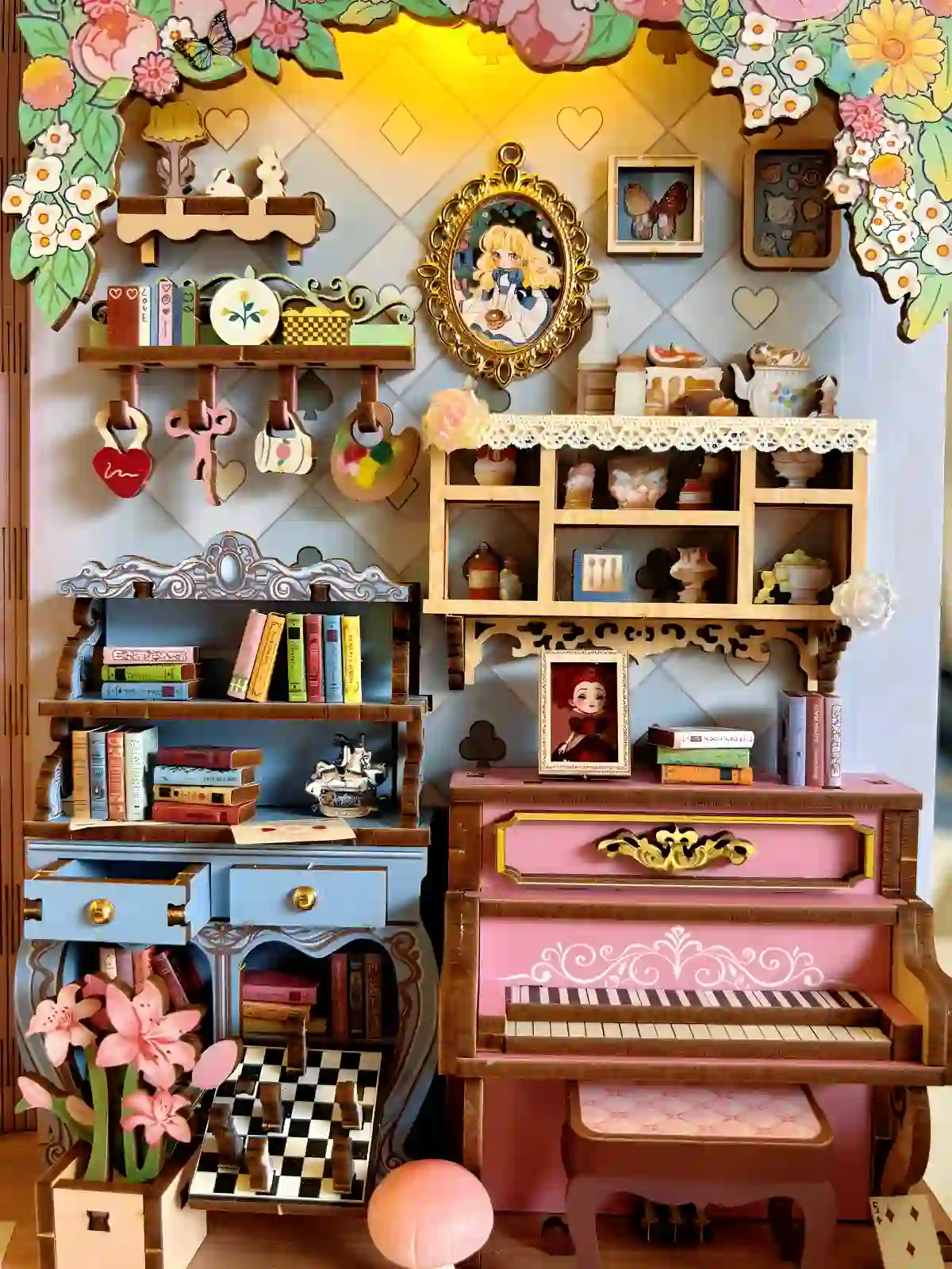 Detailed close-up of an Alice in Wonderland miniature book nook with a pink piano and detailed shelving.