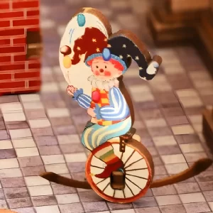 A colorful rotating clown figure on a unicycle from the Annecy Castle carousel puzzle.