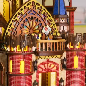 The lit-up balcony of the Fairy Tale Castle DIY Kit with a bear holding balloons.