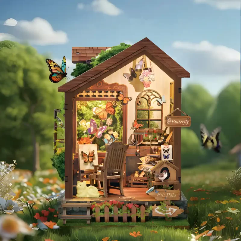 Artistic rendering of the Butterfly House DIY Book Nook Kit sitting in a sunny meadow, a beautiful nature-inspired diorama.
