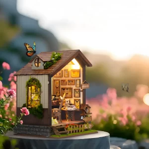A side view of the lit-up Butterfly House book nook at sunset, creating a peaceful countryside décor scene.