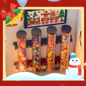 Miniature candy shop display with four tubes of colorful candies and a gingerbread train sign.