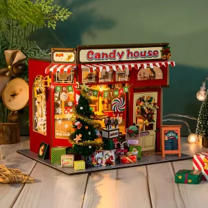 Assembled Christmas Candy House dollhouse lit up on a desk, a cozy Christmas gift idea.