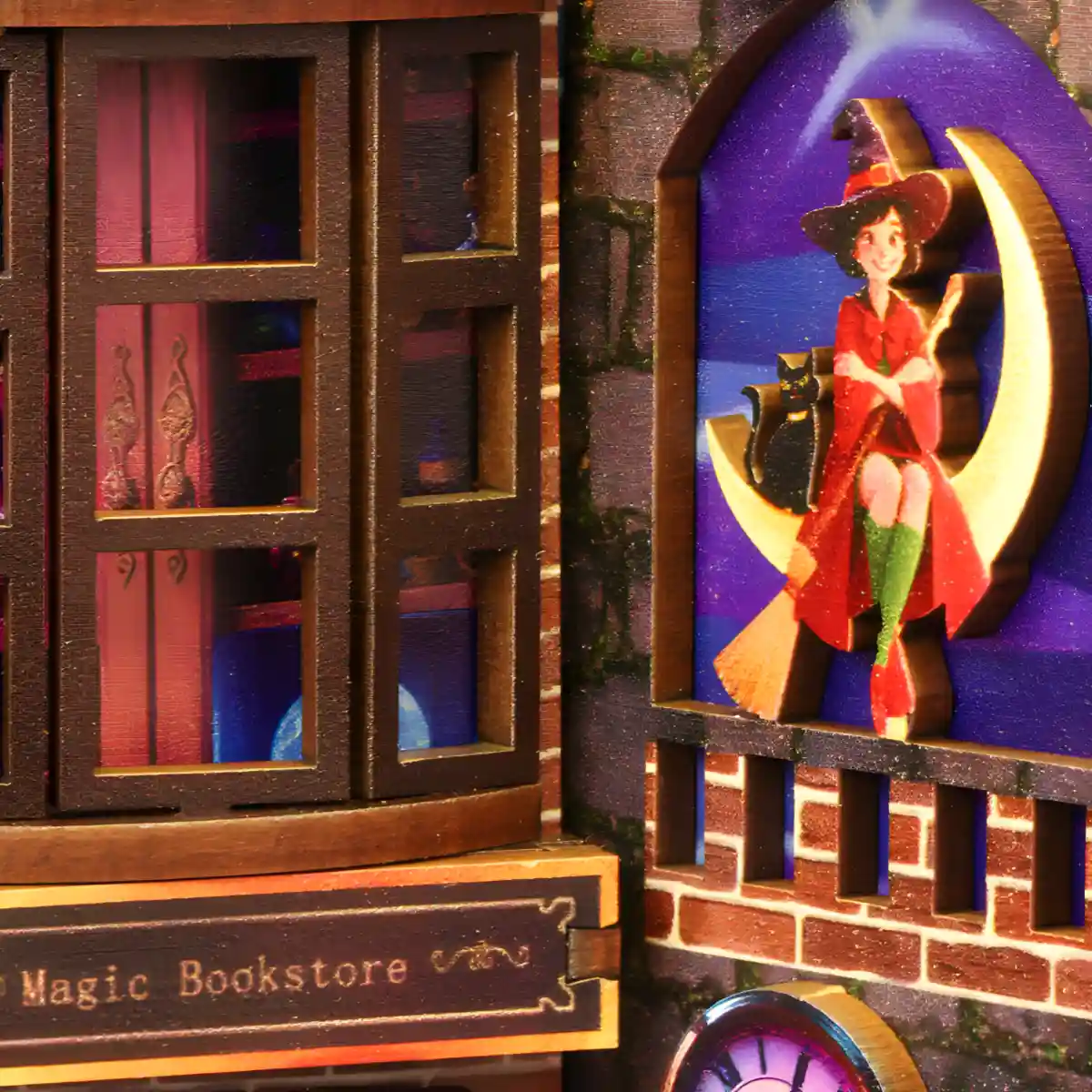 A detailed close-up of the Magic Alley book nook, showing a witch on a moon next to the glowing "Magic Bookstore" sign in a fantasy world.