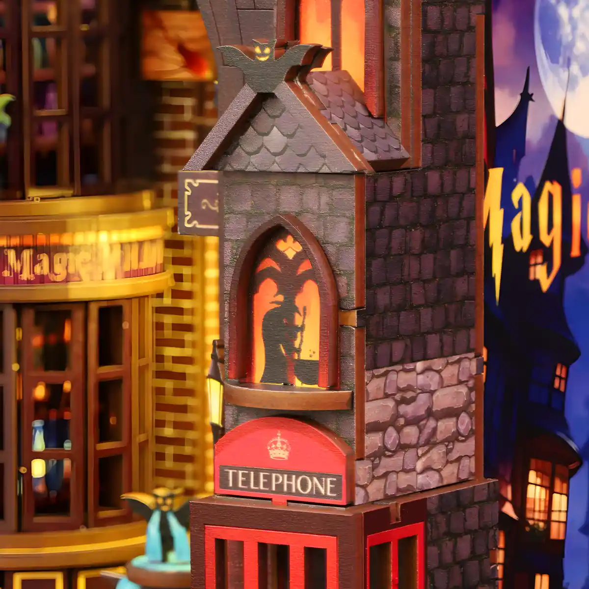 Close-up of a DIY book nook showing detailed gothic architecture and a glowing window, creating a magical wizarding atmosphere in a secret alley.